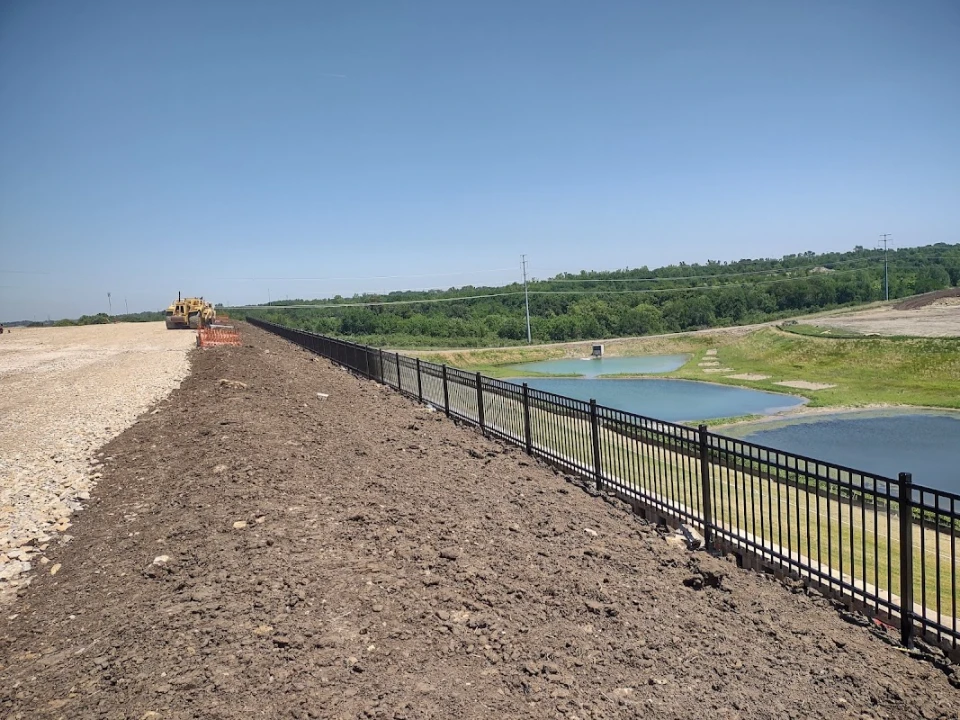 Custom farm fence project with drive gate and wire panels on a Mississippi property