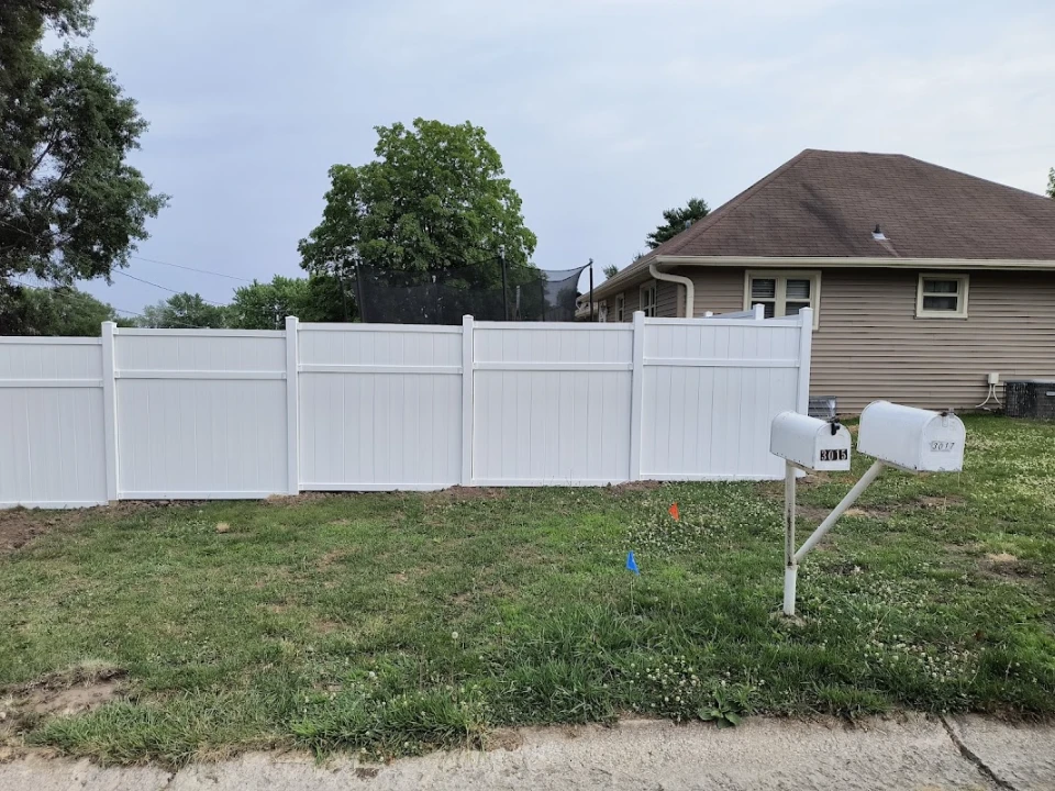 White vinyl fence enclosing a family backyard with clean panel-and-post finish in Mississippi