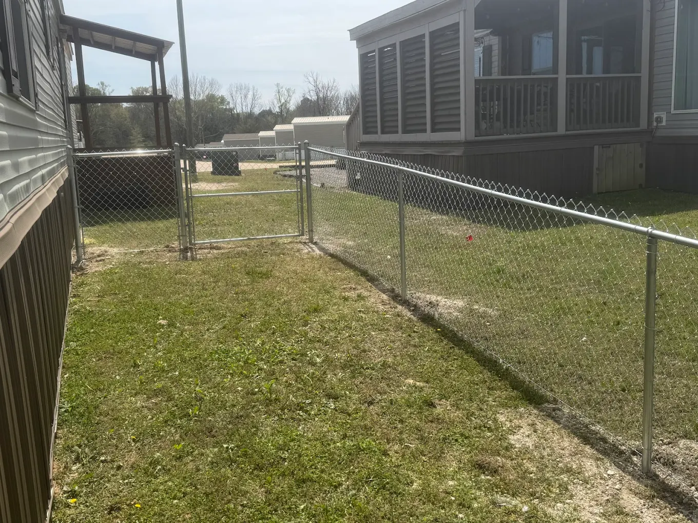 Galvanized chain link fence installation for residential property in Oktibbeha County, Mississippi
