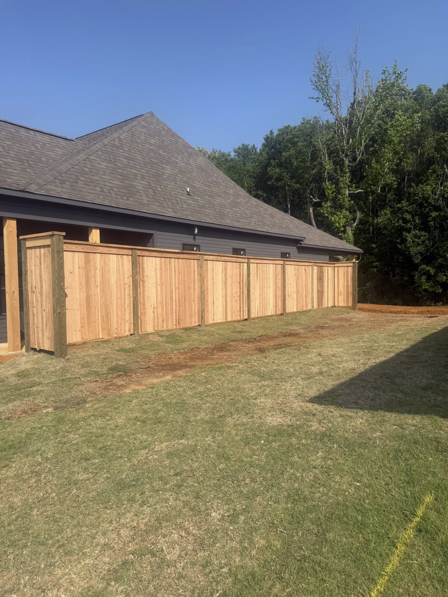 Finished wood fence installation on Starkville neighborhood lot - Golden Triangle fence company